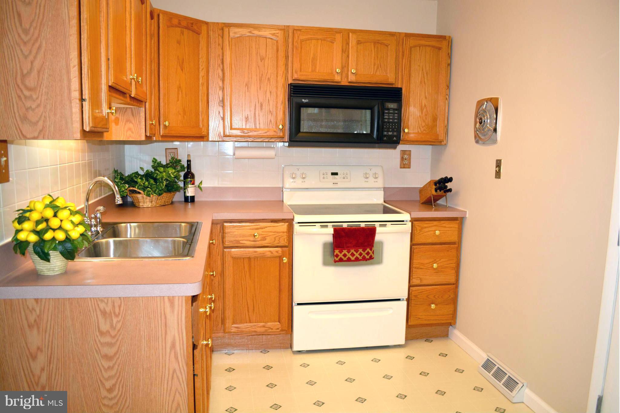 2208 Snow Road Edgewood, MD 21040 - Photo 14 of 23 a kitchen with a stove a microwave and refrigerator