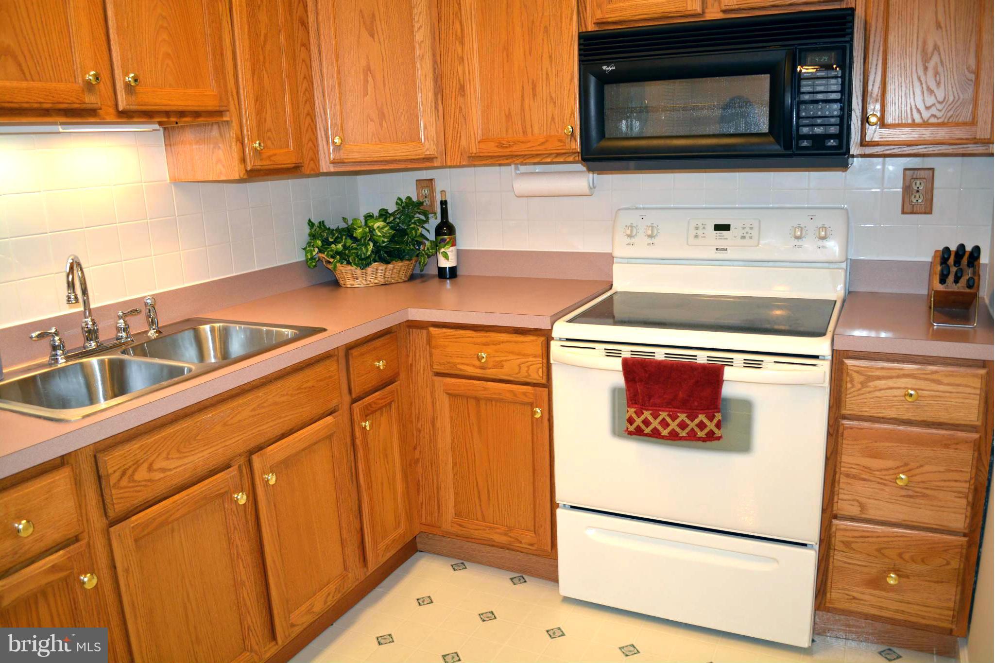 2208 Snow Road Edgewood, MD 21040 - Photo 15 of 23 a kitchen with stainless steel appliances granite countertop a sink stove and microwave