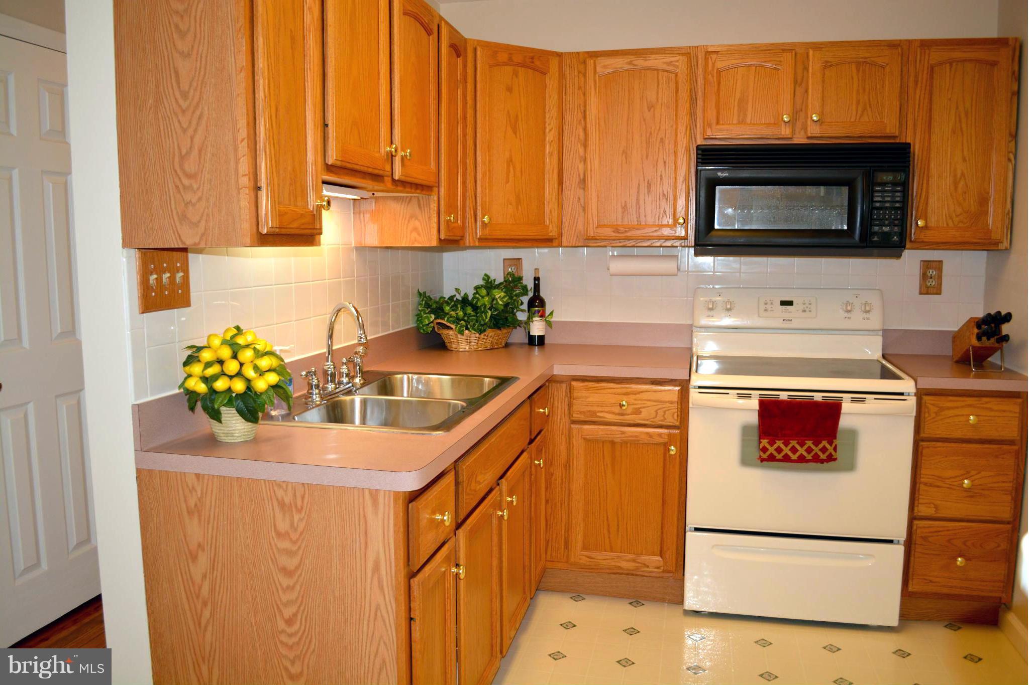 2208 Snow Road Edgewood, MD 21040 - Photo 16 of 23 a kitchen with stainless steel appliances a stove a microwave and a refrigerator