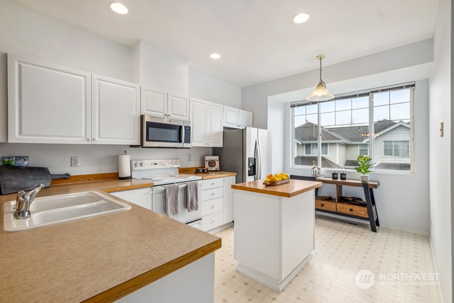 2300 Benson Road South, Unit C 3 Renton, WA 98055 - Photo 8 of 26 a kitchen with granite countertop a stove and a sink