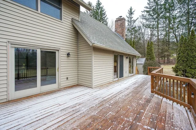a view of backyard with a deck and wooden floor