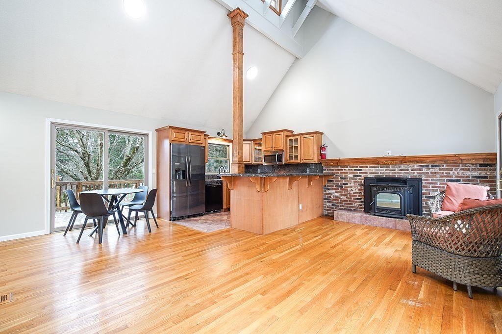 200 Brimfield Road, Unit 200 Monson, MA 01057 - Photo 2 of 13 a living room with furniture a fireplace and wooden floor