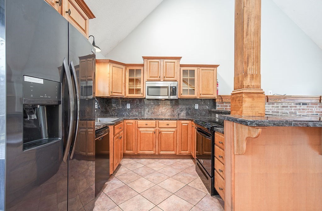 200 Brimfield Road, Unit 200 Monson, MA 01057 - Photo 4 of 13 a kitchen with stainless steel appliances granite countertop a refrigerator and a stove