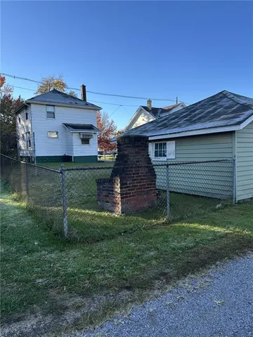 a view of a wooden house with a yard