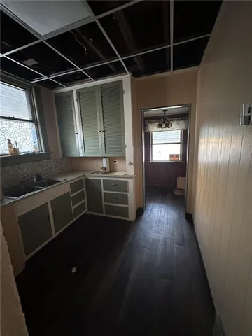 a kitchen with a refrigerator and a sink