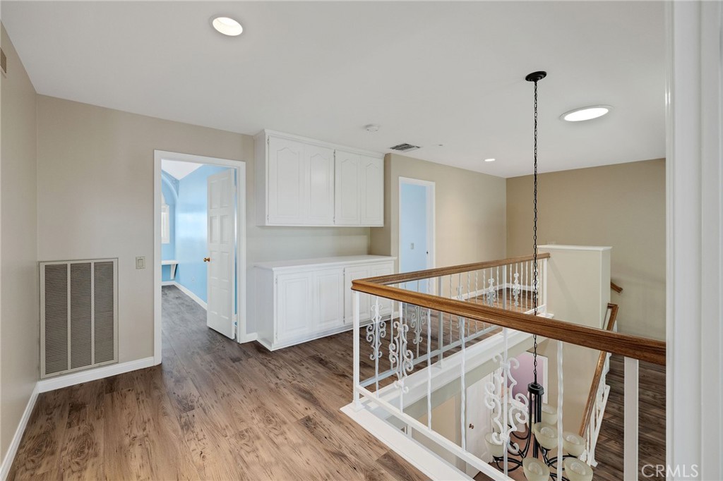 19 Village Circle Manhattan Beach, CA 90266 - Photo 14 of 26 a view of a hallway with wooden floor and stairs