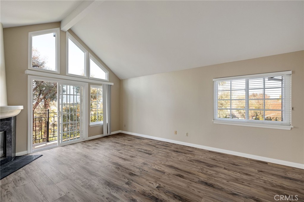 19 Village Circle Manhattan Beach, CA 90266 - Photo 16 of 26 an empty room with wooden floor and windows