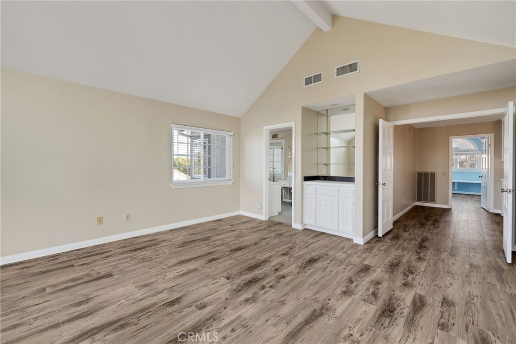 19 Village Circle Manhattan Beach, CA 90266 - Photo 17 of 26 an empty room with wooden floor and windows