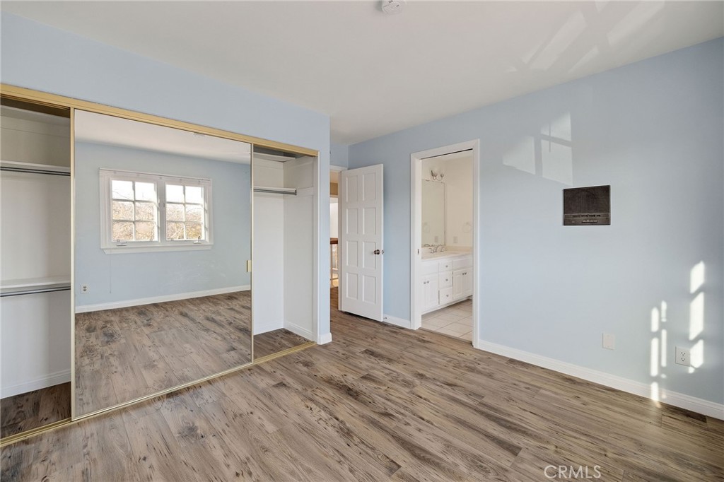 19 Village Circle Manhattan Beach, CA 90266 - Photo 23 of 26 an empty room with wooden floor and windows