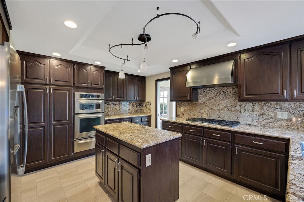 19 Village Circle Manhattan Beach, CA 90266 - Photo 7 of 26 a kitchen with stainless steel appliances granite countertop a sink refrigerator and cabinets