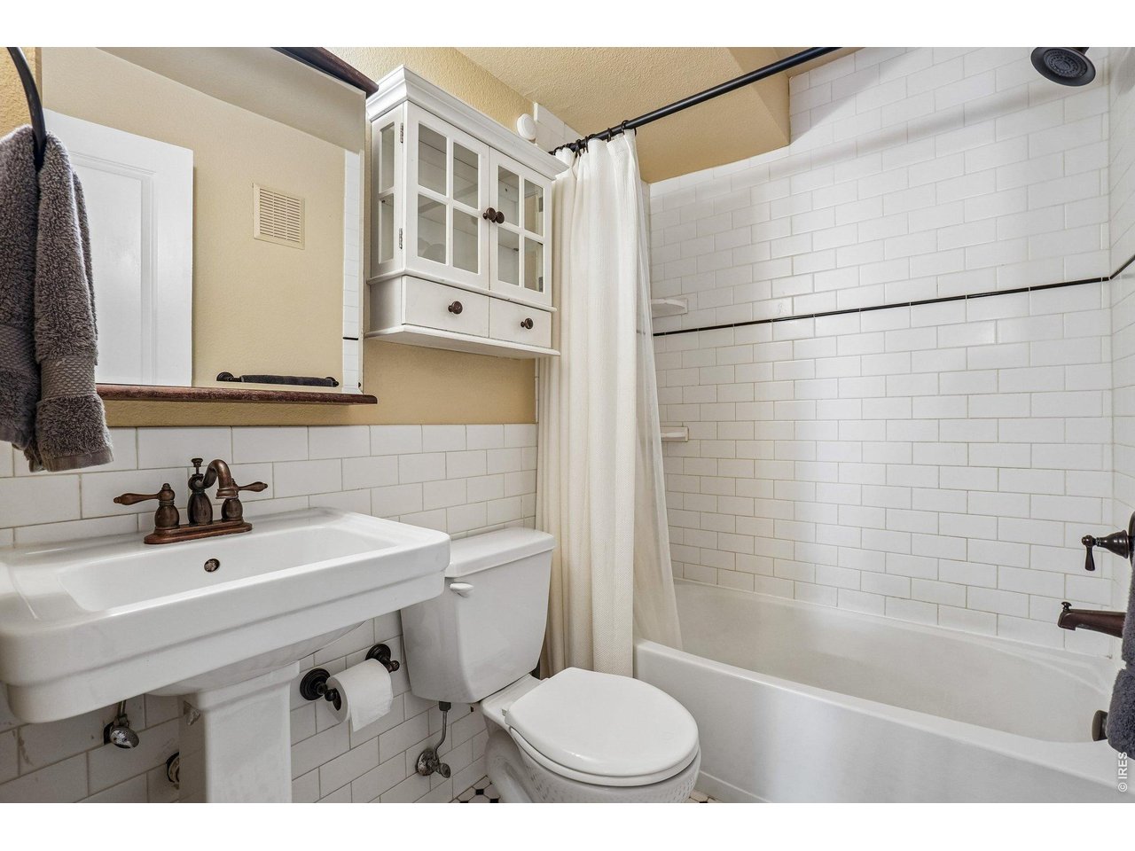 233 North Meldrum Street, Unit 4 Fort Collins, CO 80521 - Photo 10 of 16 a bathroom with a sink a toilet a mirror and shower