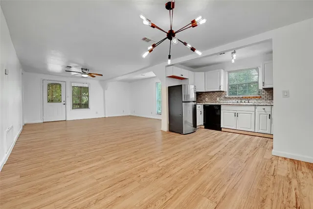 a view of a kitchen with a sink and a stove top oven