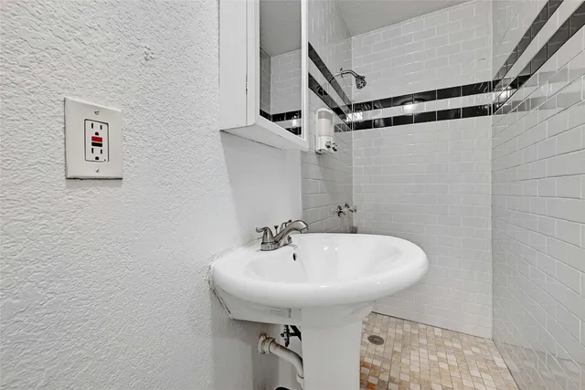 a bathroom with a sink and mirror