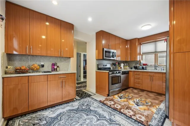 a kitchen with stainless steel appliances granite countertop a refrigerator sink and cabinets