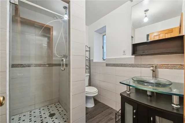 a bathroom with a sink a toilet and shower