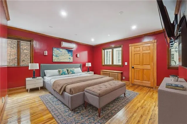 a bedroom with a bed and a chandelier