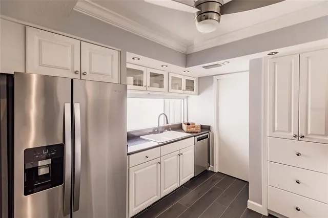 a kitchen with stainless steel appliances a refrigerator sink and cabinets