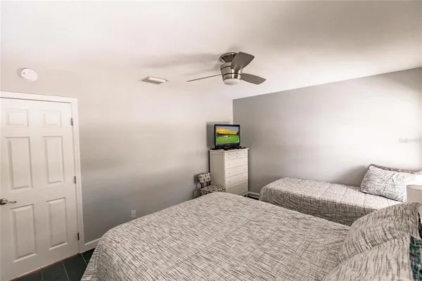 a bedroom with a bed and a chandelier