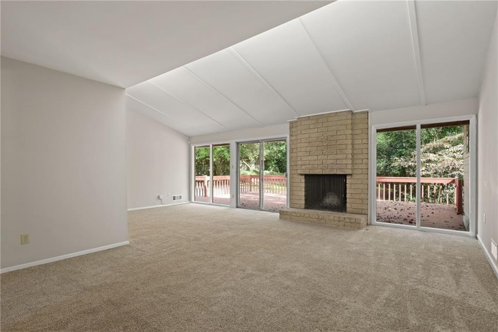 705 Edgewater Trail Sandy Springs, GA 30328 - Photo 3 of 36 a view of a livingroom with a fireplace and a window
