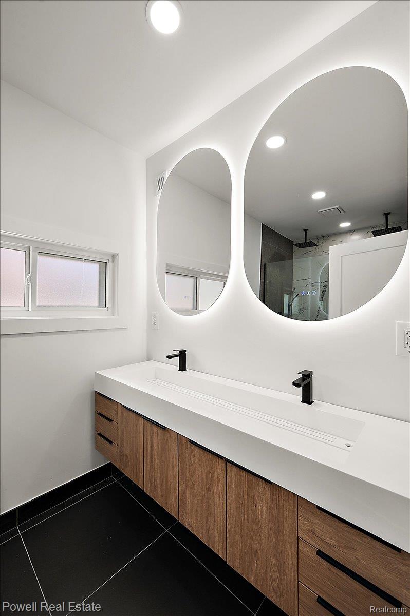 6837 Hatchery Road Waterford, MI 48327 - Photo 28 of 56 Bathroom with double vanity, recessed lighting, a shower, and dark tile patterned floors