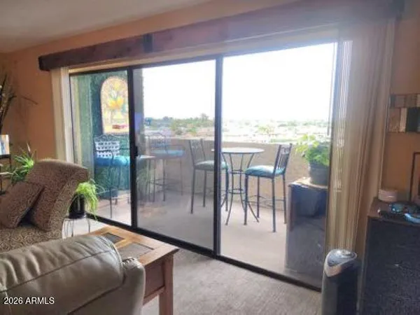 a bedroom with furniture and a floor to ceiling window