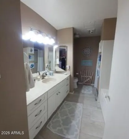 a spacious bathroom with a double vanity sink a mirror and a shower