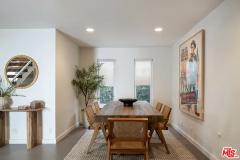 a view of a dining room with furniture and a potted plant