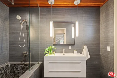 a bathroom with a shower and a sink
