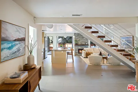 a dining room with wooden floor and furniture