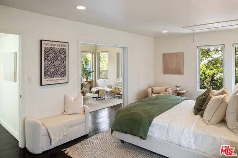 a bedroom with a bed couch and a window