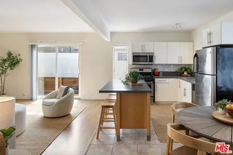 a kitchen with sink refrigerator and microwave