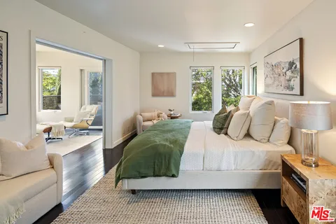 a bedroom with a large bed and a couch