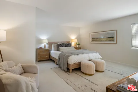 a bedroom with bed and a couch