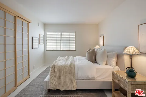 a bedroom with a bed and a lamp