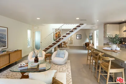 a lobby with furniture and stairs