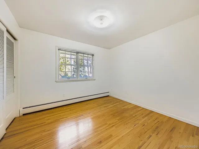 a view of an empty room and wooden floor