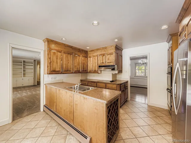 a kitchen with a large window appliances and cabinets