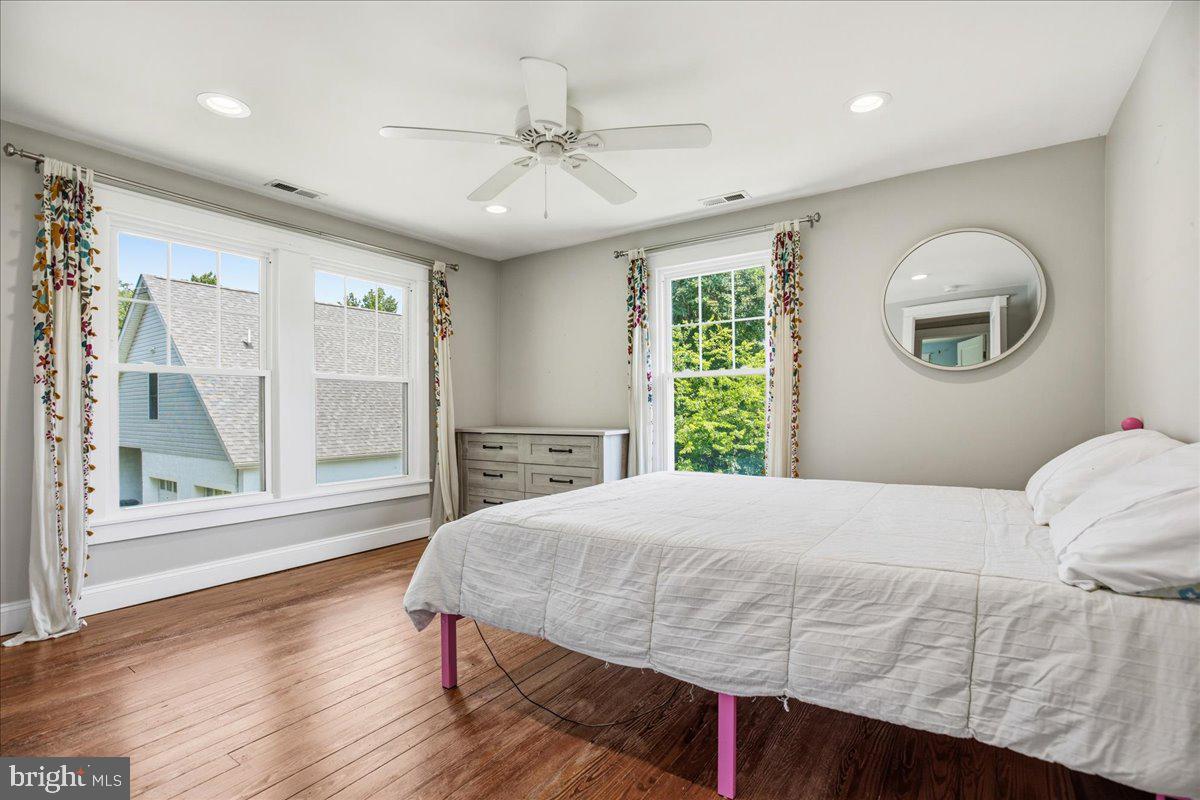 16146 Thomas Road Piney Point, MD 20674 - Photo 42 of 70 a bedroom with a large bed and a large window