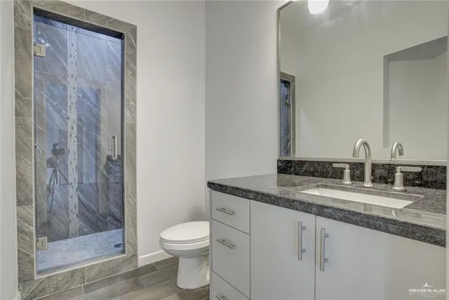 a view of a kitchen with a sink and dishwasher a kitchen island with wooden floor