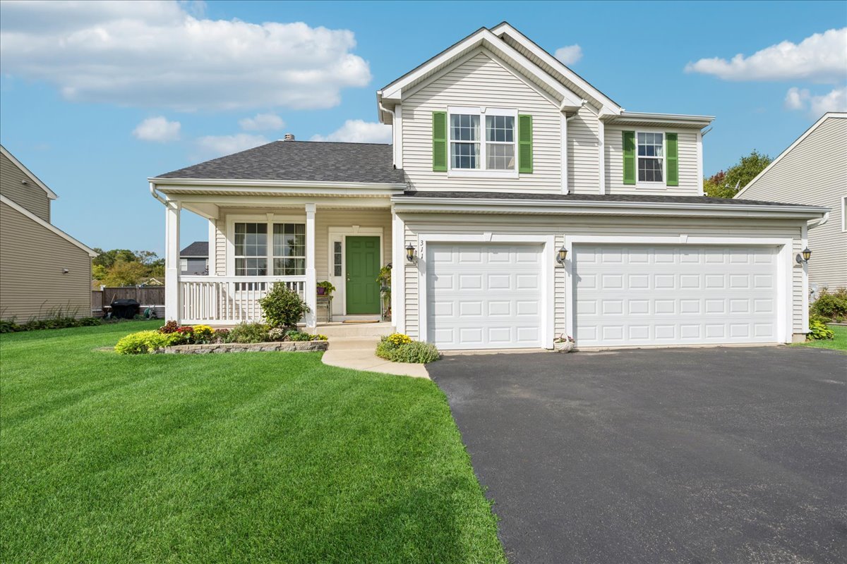 311 Market Street Genoa, IL 60135 - Photo 1 of 24 a view of a house with a yard