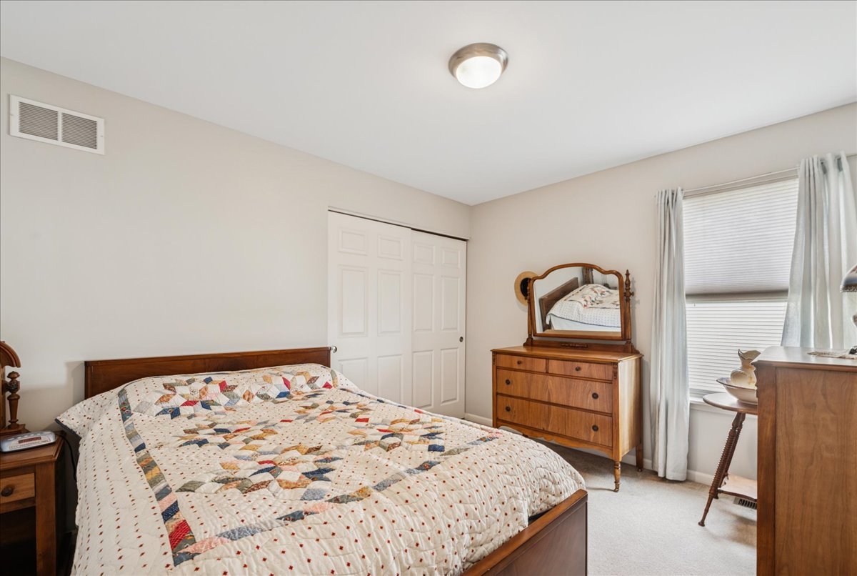 311 Market Street Genoa, IL 60135 - Photo 14 of 24 a bedroom with a bed and a dresser
