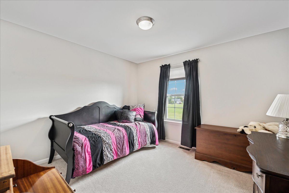 311 Market Street Genoa, IL 60135 - Photo 16 of 24 a bedroom with a bed and a window