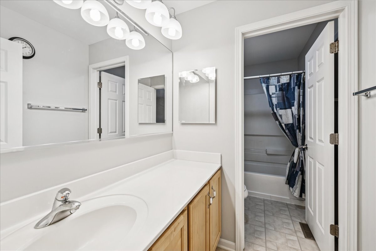 311 Market Street Genoa, IL 60135 - Photo 17 of 24 a bathroom with a sink and a mirror
