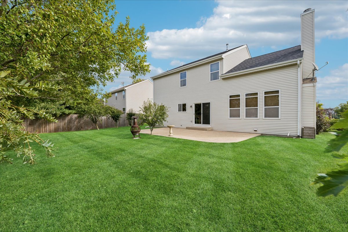 311 Market Street Genoa, IL 60135 - Photo 19 of 24 a view of a house with backyard and a tree