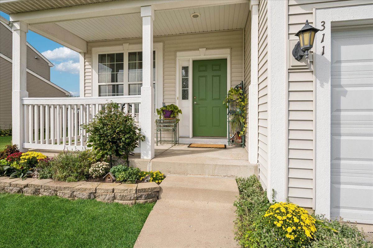 311 Market Street Genoa, IL 60135 - Photo 2 of 24 a front view of a house with a garden