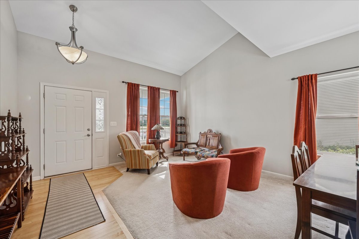 311 Market Street Genoa, IL 60135 - Photo 3 of 24 a dining room with furniture a chandelier and wooden floor