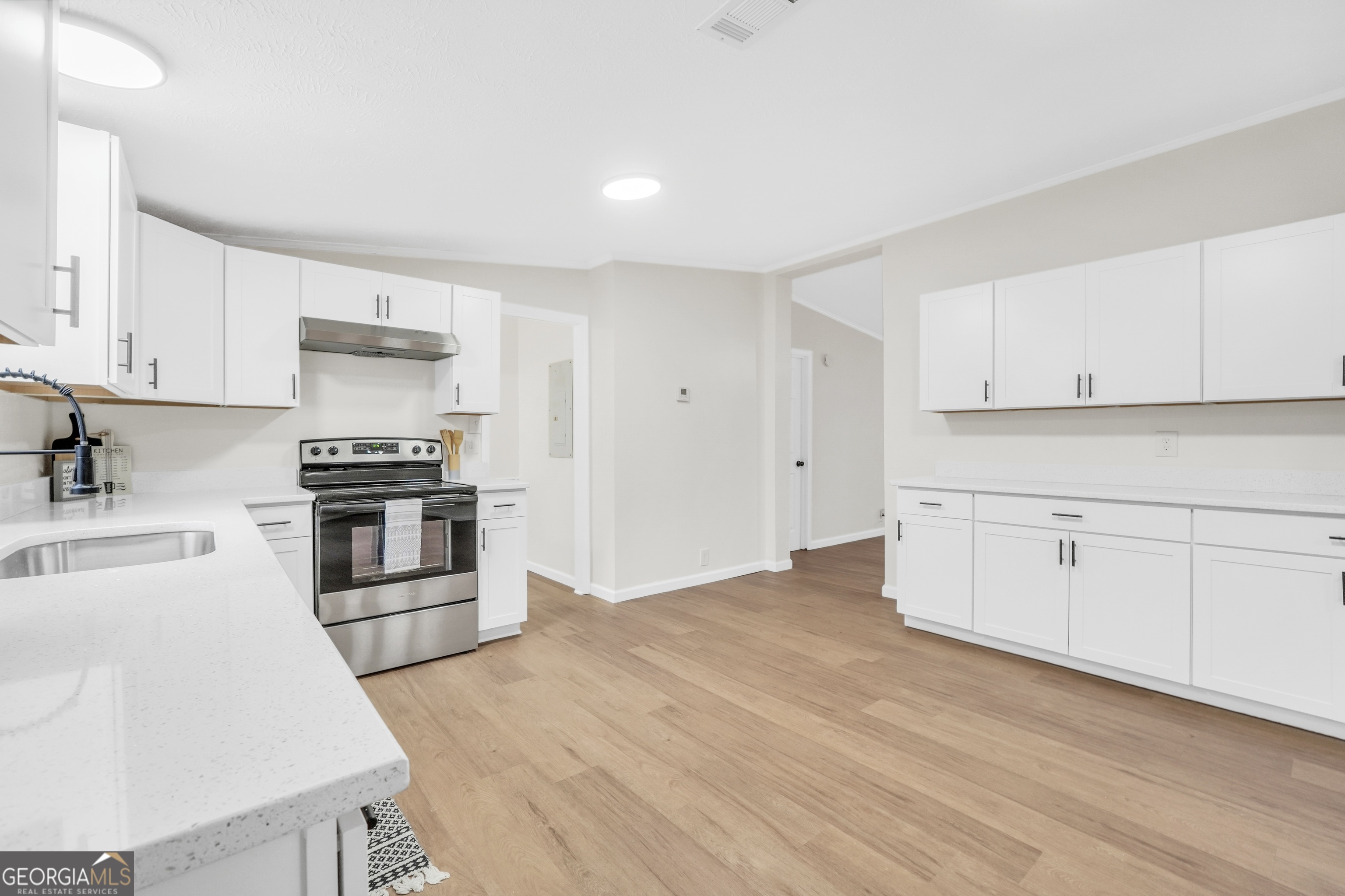 196 Craig Road Forsyth, GA 31029 - Photo 11 of 39 a kitchen with granite countertop white cabinets and stainless steel appliances