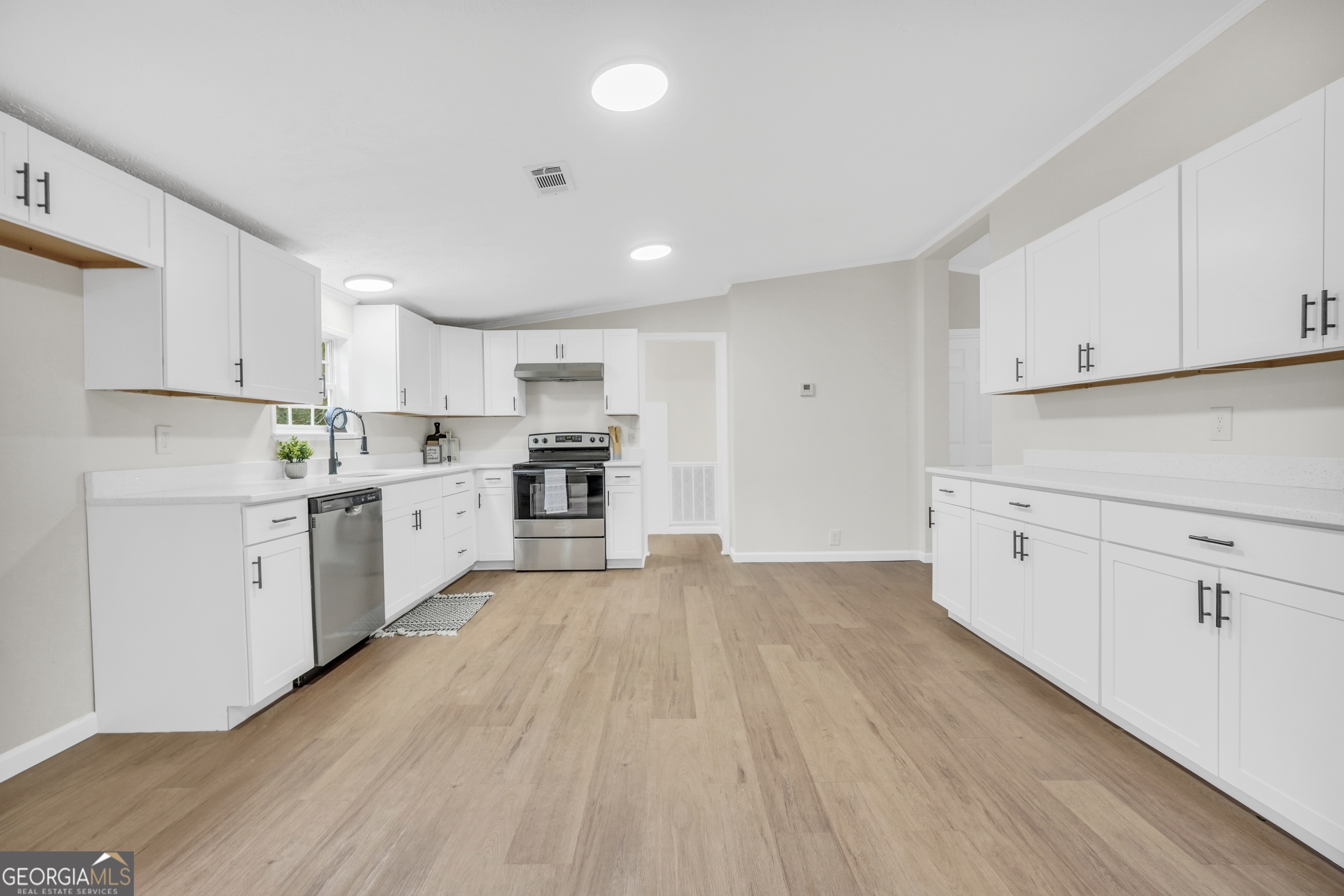 196 Craig Road Forsyth, GA 31029 - Photo 12 of 39 a view of kitchen with wooden floor sink electronic appliances and cabinets