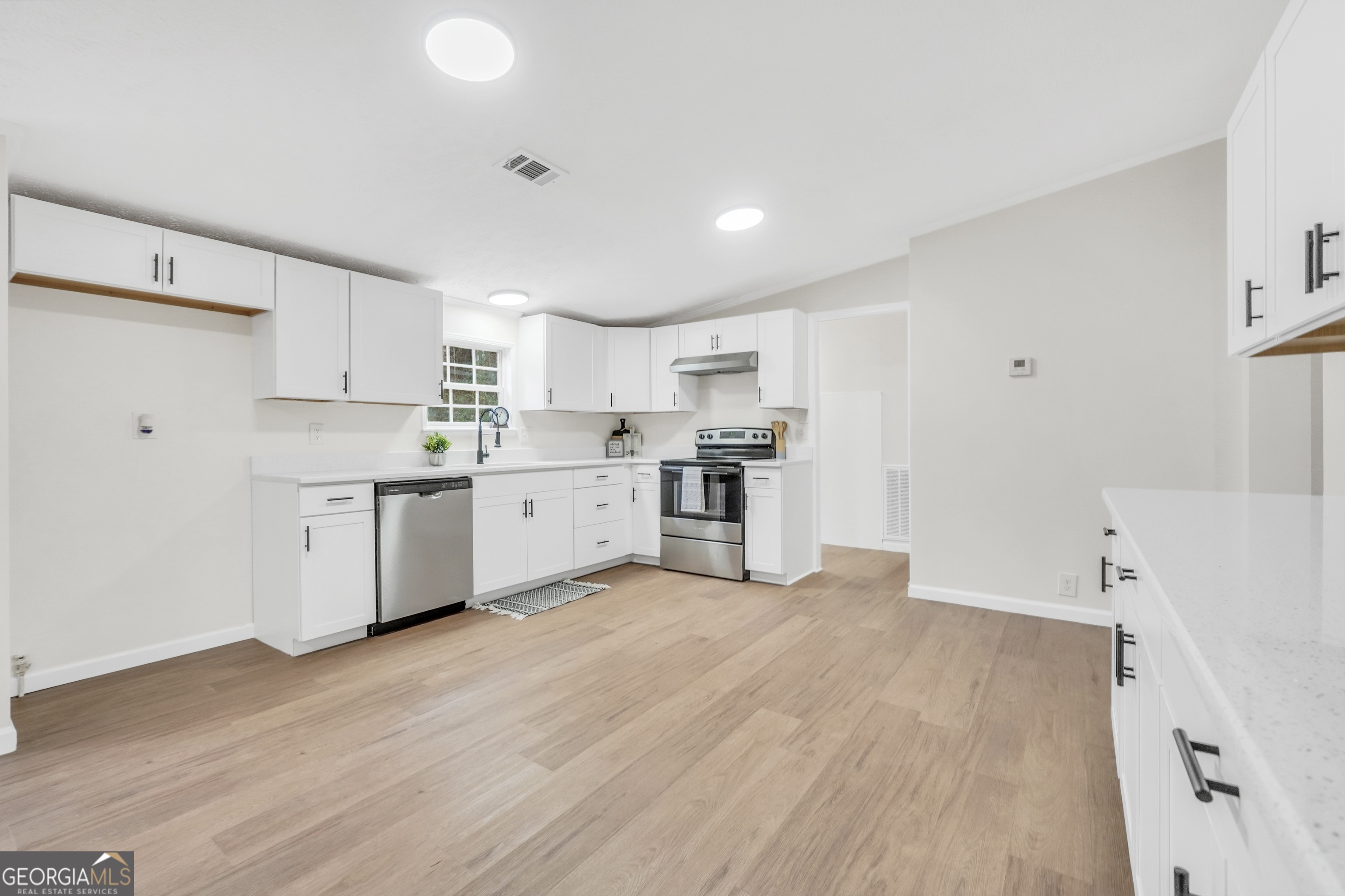 196 Craig Road Forsyth, GA 31029 - Photo 13 of 39 a view of kitchen with wooden floor