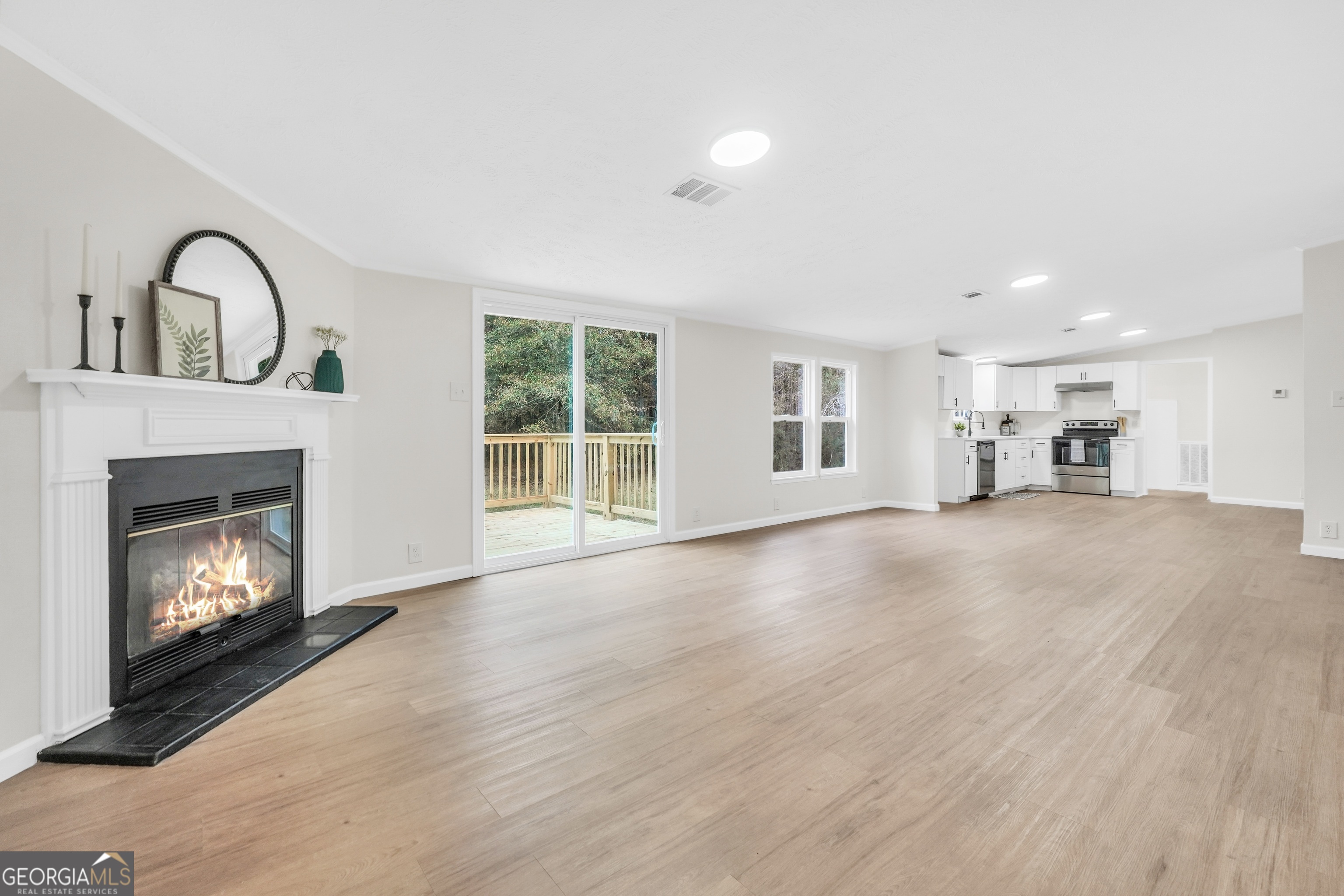 196 Craig Road Forsyth, GA 31029 - Photo 17 of 39 a view of an empty room with a fireplace and a window